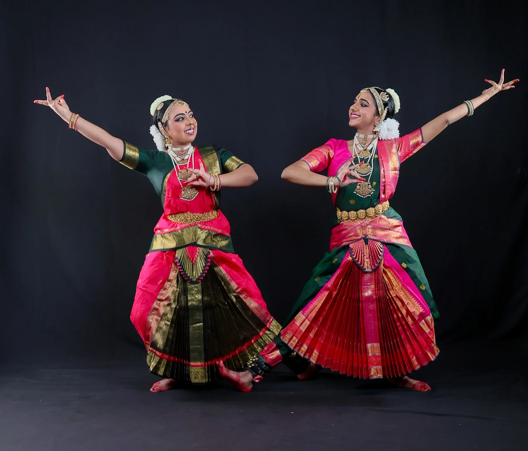 Shreya and Shriya in a synchronized Bharatanatyam pose