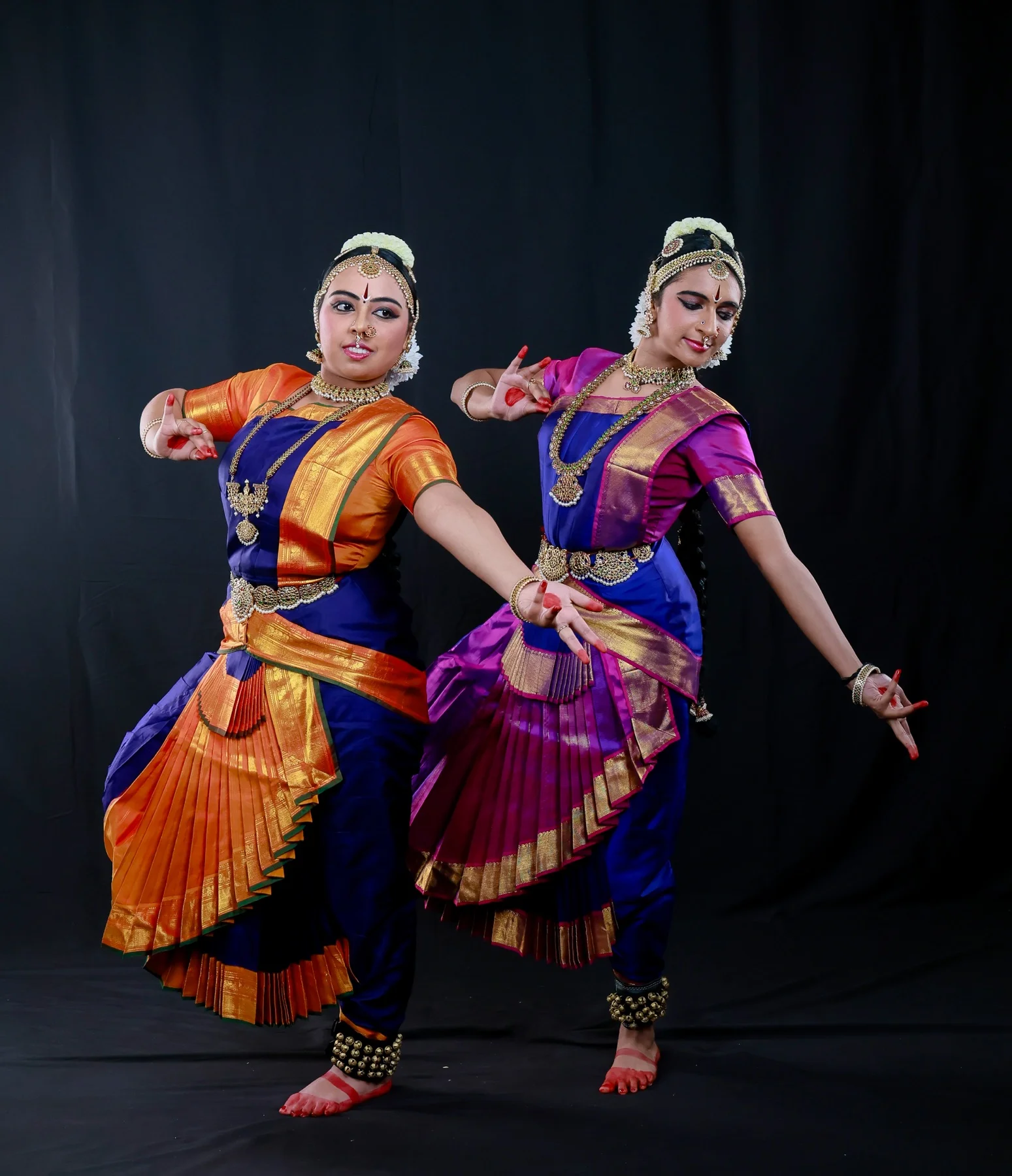 Shreya and Shriya forming an asymmetrical nritta pose