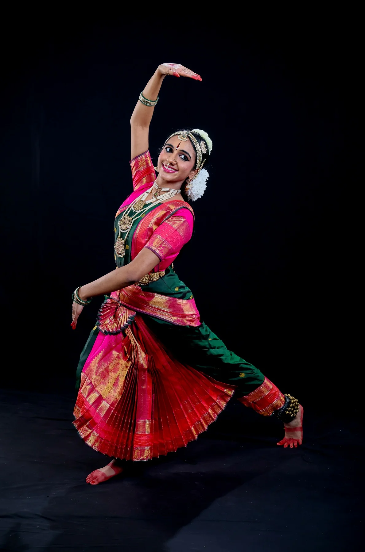 Shriya in a full-body motion pose with lifted arm and sweeping skirt for the Kavadi Chindu