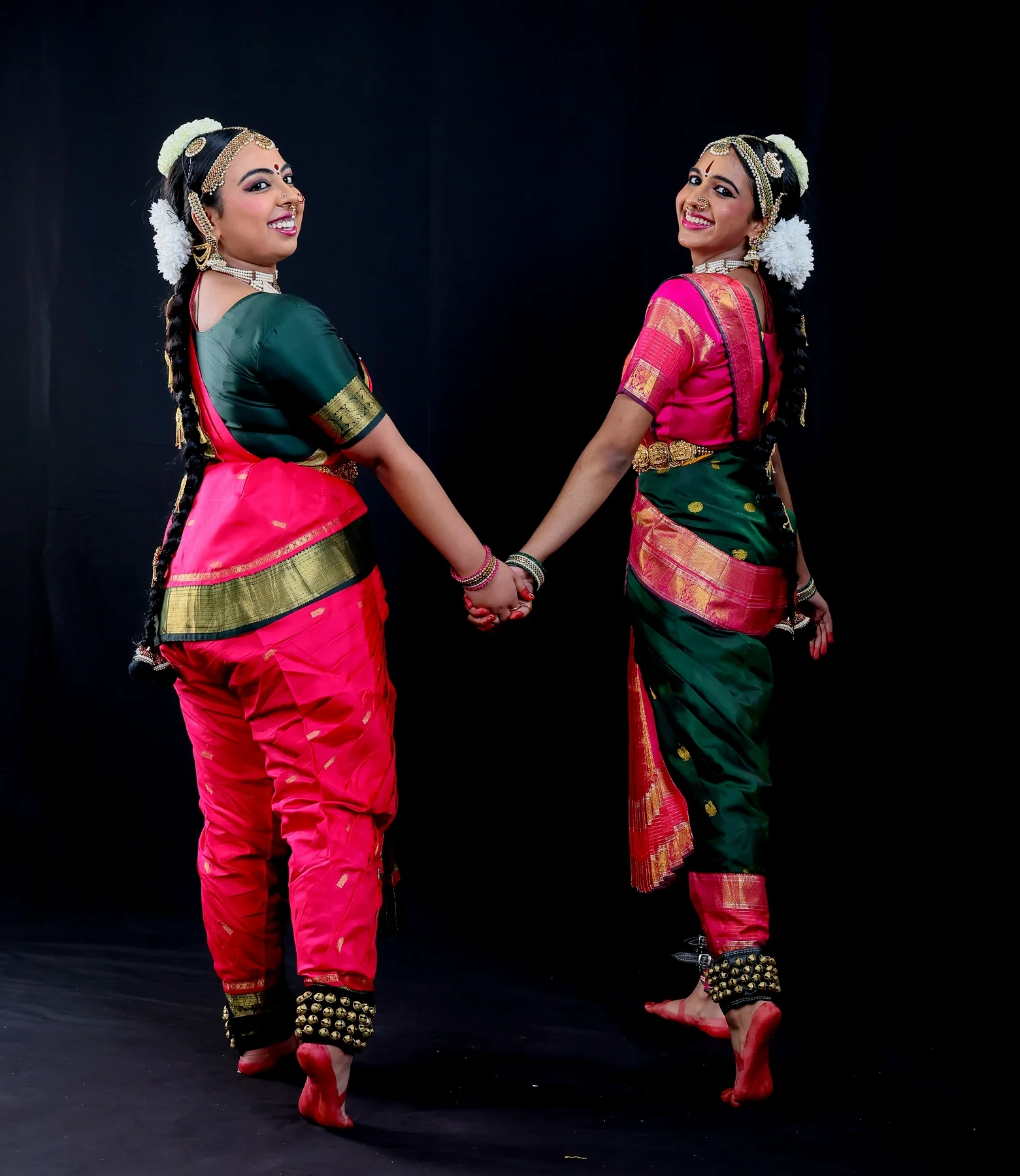 Shreya and Shriya in a back-view handholding duo pose for the closing Mangalam
